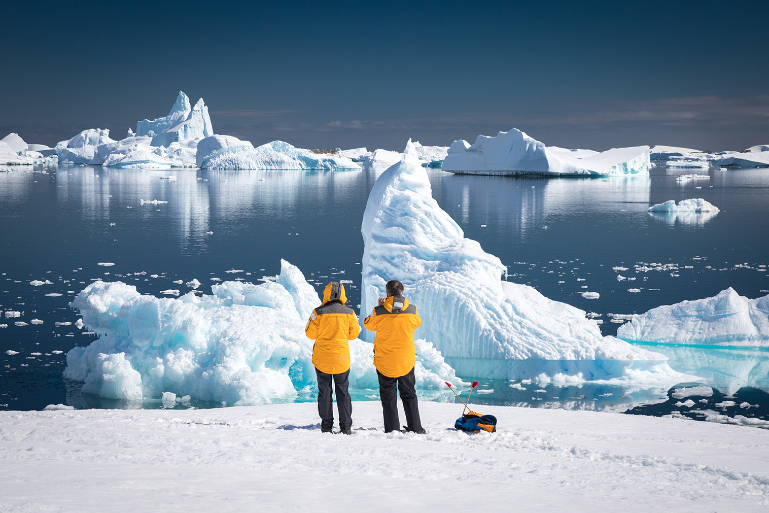 Guests-looking-at-icebergs-in-Port-Charcot-in-Antarctica-Quark Guests looking at icebergs in Port Charcot