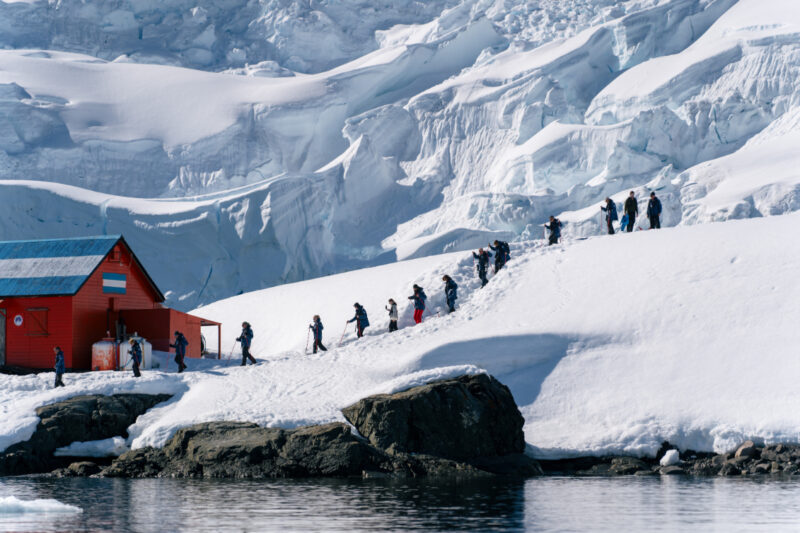 Antarctica scenery with guests hiking
