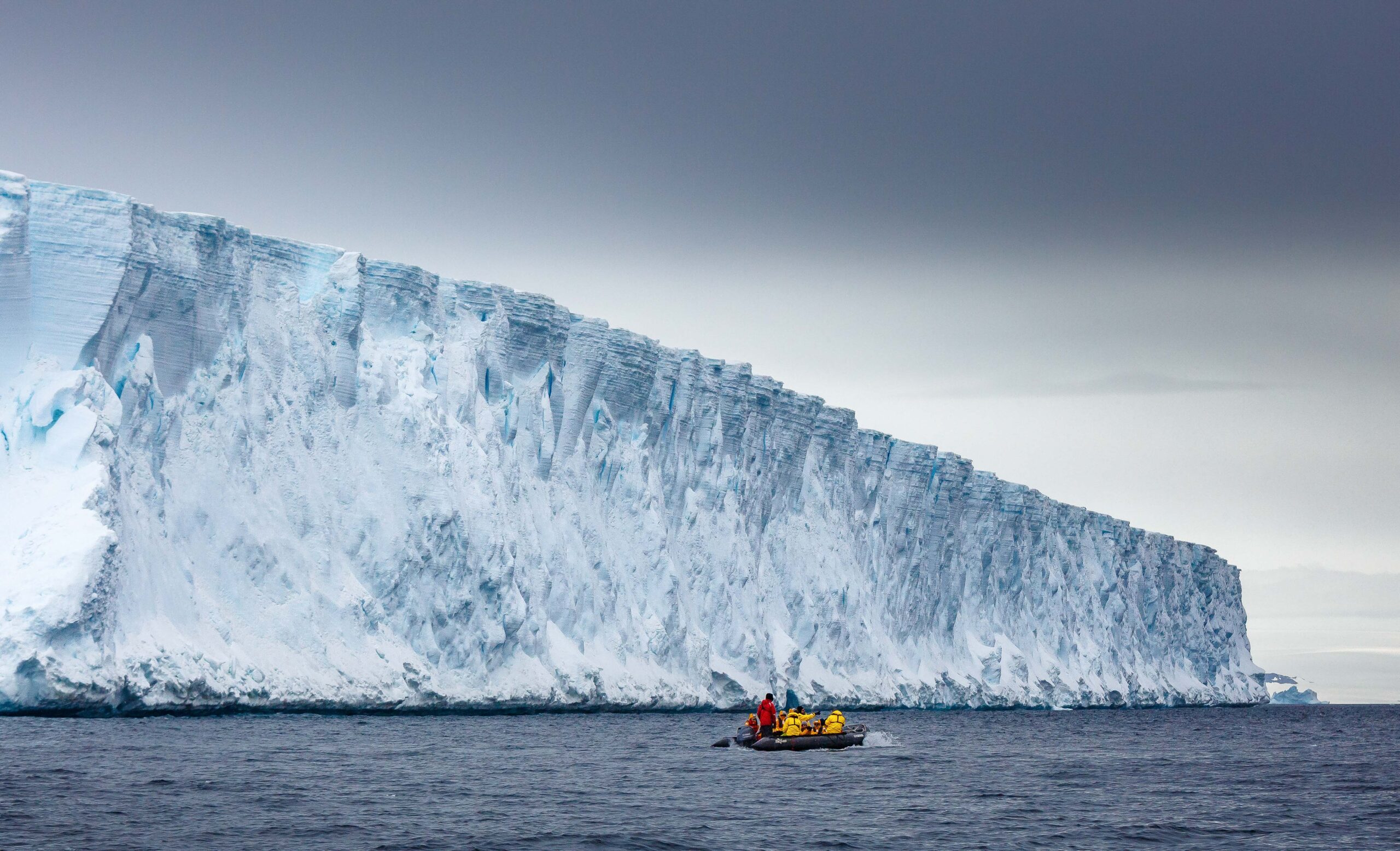 Zodiac-cruising-by-Glacier-in-Antarctica--Quark zodiac by glacier