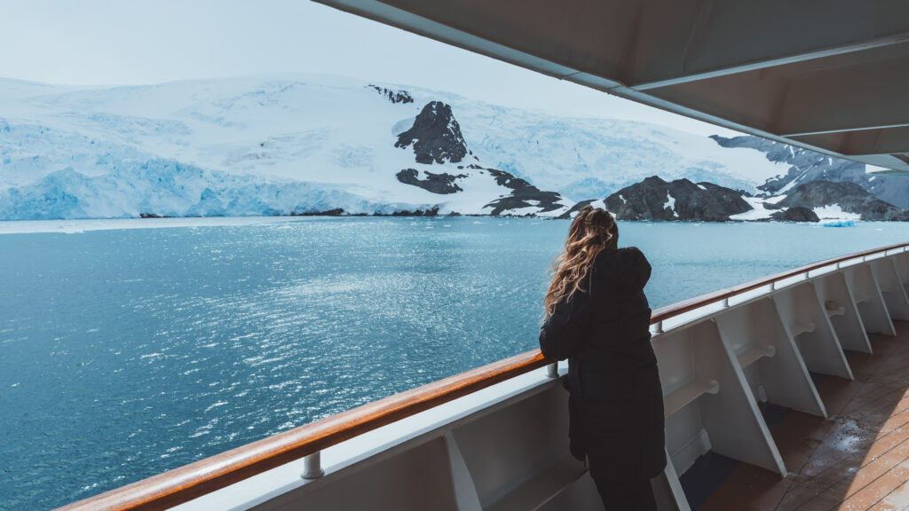 a girl on the deck of an expedition cruise ship in Antarctica