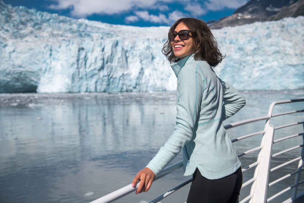 a lady by a glacier during the summer