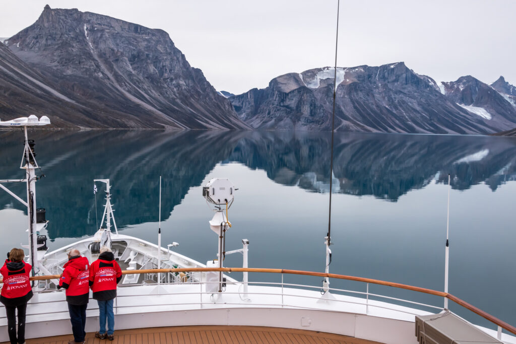 guests standing on deck of an expedition ship in the northwest passage