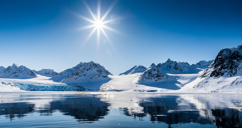 midnight sun over a landscape of mountains in Svalbard