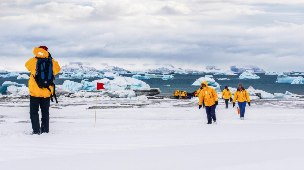 tourists exploring the shore in Antarctica