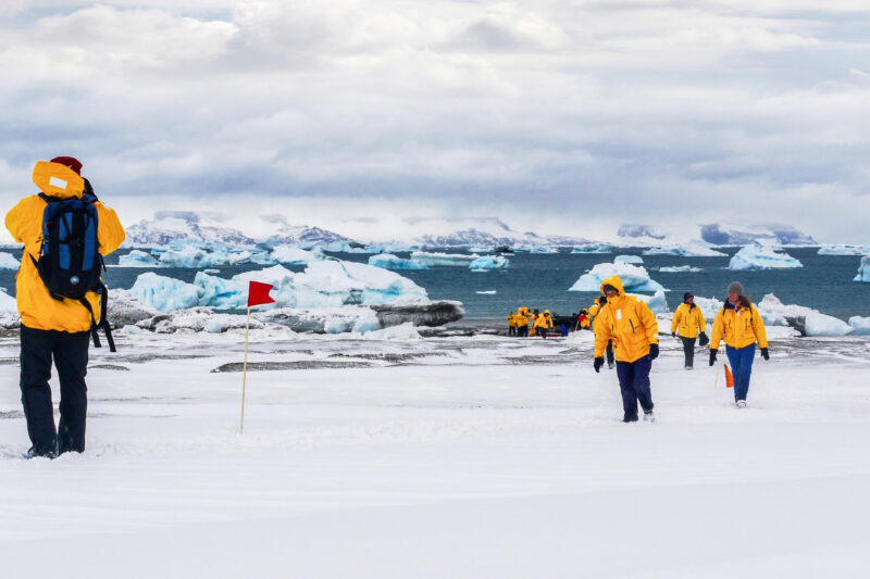 tourists exploring the shore in Antarctica