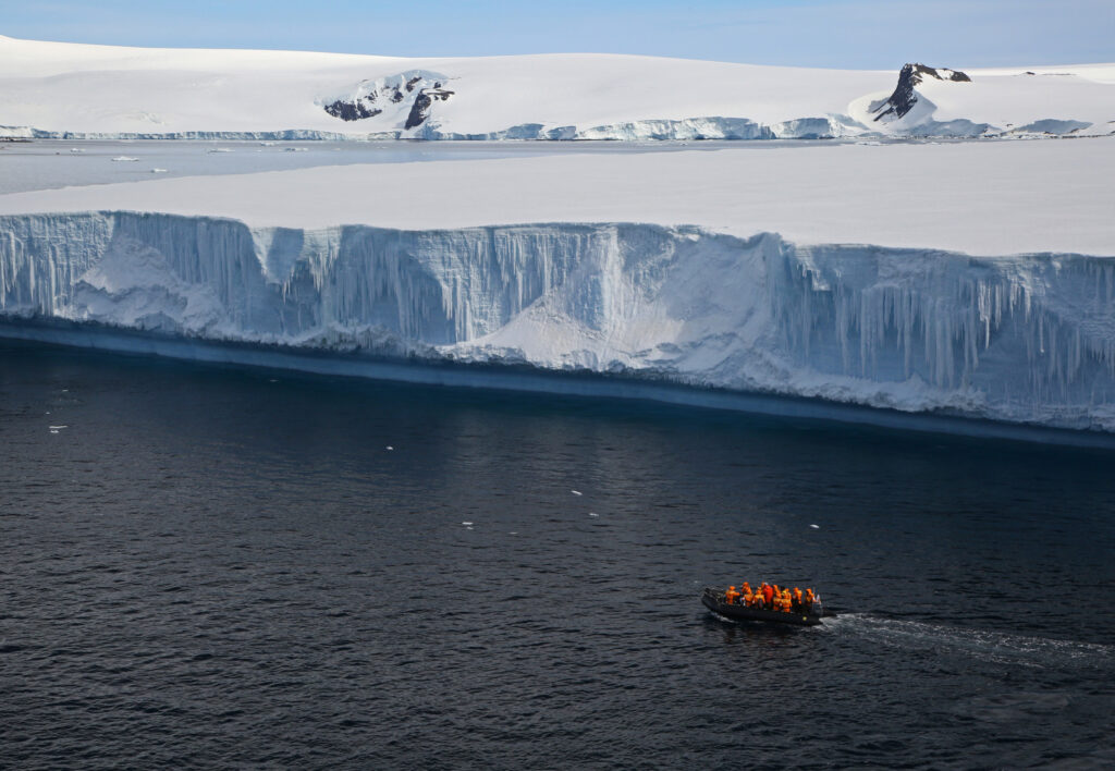 zodiac cruising past a glacier in Antarctica on an expedition cruise